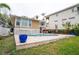 A backyard view featuring pool, lush landscaping, patio and multi-story home at 5169 Oxford Dr, Sarasota, FL 34242