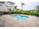 Backyard view featuring a freeform pool surrounded by lush tropical landscaping at 5169 Oxford Dr, Sarasota, FL 34242