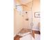 Modern glass enclosed shower with stone tile floor, tiled walls, and brushed fixtures at 5169 Oxford Dr, Sarasota, FL 34242
