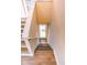 View of the stairs descending, wood floors and white risers at 5169 Oxford Dr, Sarasota, FL 34242