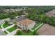 Aerial view showcasing a two-story home with lush lawn and screened pool at 7114 Mill Hopper Ct, Palmetto, FL 34221