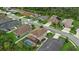 Aerial view showcasing a two-story home with lush lawn and screened pool at 7114 Mill Hopper Ct, Palmetto, FL 34221
