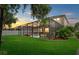 Lush backyard featuring a screened pool, patio, and well-manicured lawn at 7114 Mill Hopper Ct, Palmetto, FL 34221