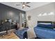 This bedroom features a dark accent wall, a ceiling fan and neon shoe decorations at 7114 Mill Hopper Ct, Palmetto, FL 34221