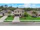 Beautiful two-story home with stone accents, a well-manicured lawn, and lush landscaping at 7114 Mill Hopper Ct, Palmetto, FL 34221
