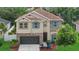 Two-story home with stone accents, covered entryway, and mature landscaping at 7114 Mill Hopper Ct, Palmetto, FL 34221