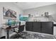 Modern home office with sleek black cabinets, dual monitors, and stylish decor accents at 7114 Mill Hopper Ct, Palmetto, FL 34221