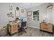 Comfortable home office with hardwood floors, a large desk, and natural lighting at 7114 Mill Hopper Ct, Palmetto, FL 34221