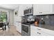 Modern kitchen with stainless steel appliances, granite countertops, and ample storage space at 7114 Mill Hopper Ct, Palmetto, FL 34221