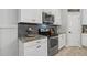 Close-up of modern kitchen showcasing stainless steel appliances, granite counters, and stylish backsplash at 7114 Mill Hopper Ct, Palmetto, FL 34221