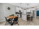 Bright kitchen features a center island with bar seating, stainless steel appliances, and a modern dining area at 7114 Mill Hopper Ct, Palmetto, FL 34221