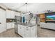 Stylish kitchen with white cabinetry, stainless appliances, and an island, seamlessly connected to living area at 7114 Mill Hopper Ct, Palmetto, FL 34221