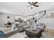 Open-concept living room with neutral colors, tile flooring, and seamless flow to the kitchen at 7114 Mill Hopper Ct, Palmetto, FL 34221