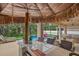 Resort-style outdoor kitchen with tiki bar, grill, and island seating by the screened in pool area at 7114 Mill Hopper Ct, Palmetto, FL 34221