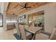 Spacious outdoor patio with wood ceiling, string lights, and access to the screened-in pool and backyard at 7114 Mill Hopper Ct, Palmetto, FL 34221
