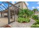 Covered pool area with a tiki bar and beautiful tropical landscaping at 7114 Mill Hopper Ct, Palmetto, FL 34221