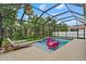 Enjoy this screened-in pool with lounge chairs and a fun pink flamingo float at 7114 Mill Hopper Ct, Palmetto, FL 34221