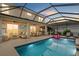Stunning pool with tiki bar and screened-in patio, perfect for outdoor entertaining at 7114 Mill Hopper Ct, Palmetto, FL 34221