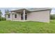 The backyard features a covered patio and sliding door at 14362 San Domingo Blvd, Port Charlotte, FL 33981