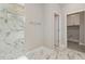 Modern bathroom with walk-in shower, decorative marble tile and a laundry area just through the doorway at 14362 San Domingo Blvd, Port Charlotte, FL 33981