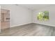 Bright bedroom with hardwood floors and a large window overlooking backyard landscaping at 14362 San Domingo Blvd, Port Charlotte, FL 33981