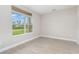 A bright, vacant room with a large window providing natural light and outdoor views at 14362 San Domingo Blvd, Port Charlotte, FL 33981