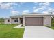 Beautiful single-story home featuring an attached garage, manicured lawn, and neutral-toned stucco exterior at 14362 San Domingo Blvd, Port Charlotte, FL 33981