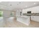 Spacious open-plan kitchen features pendant lighting, modern appliances, and eat in island at 14362 San Domingo Blvd, Port Charlotte, FL 33981