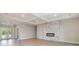 Bright open-plan living room with wood-look flooring, modern fireplace, and sliding glass doors to outside at 14362 San Domingo Blvd, Port Charlotte, FL 33981