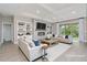 Staged living room features a stylish fireplace, built-in bookshelves, and comfortable sofas at 14362 San Domingo Blvd, Port Charlotte, FL 33981