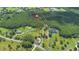 Expansive property featuring lush greenery, a pond, and a secluded home nestled within a private wooded area at 11933 Pasco Trails Blvd, Spring Hill, FL 34610