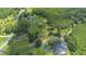 A grand estate with sprawling lawns, a private pond, a luxurious pool, and a charming circular driveway at 11933 Pasco Trails Blvd, Spring Hill, FL 34610