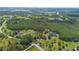 Expansive aerial view of wooded property with multiple homes, ponds and long driveways at 11933 Pasco Trails Blvd, Spring Hill, FL 34610
