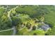 Aerial view displays luxurious homes nestled within sprawling greenery, ponds and private drives at 11933 Pasco Trails Blvd, Spring Hill, FL 34610