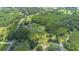 Expansive property featuring lush greenery, a pond, and a secluded home nestled within a private wooded area at 11933 Pasco Trails Blvd, Spring Hill, FL 34610