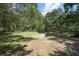 Large backyard clearing with shade trees, perfect for a secluded oasis in the woods at 11933 Pasco Trails Blvd, Spring Hill, FL 34610