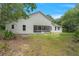 A fenced backyard with a screened-in porch to enjoy the outdoors at 11933 Pasco Trails Blvd, Spring Hill, FL 34610