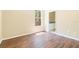 Light-filled bedroom with wood floors, window, and neutral walls at 11933 Pasco Trails Blvd, Spring Hill, FL 34610