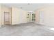 Spacious carpeted bedroom featuring multiple entryways, natural light, and a neutral color palette at 11933 Pasco Trails Blvd, Spring Hill, FL 34610