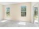 Bright bedroom featuring neutral carpet, lots of natural light, and back yard views at 11933 Pasco Trails Blvd, Spring Hill, FL 34610