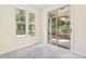 Bedroom featuring neutral carpet, lots of natural light, and back porch access at 11933 Pasco Trails Blvd, Spring Hill, FL 34610