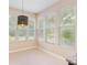 Bright breakfast nook with natural light from large windows offering backyard views at 11933 Pasco Trails Blvd, Spring Hill, FL 34610