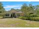 Charming single-story home with a well-manicured lawn and lush landscaping at 11933 Pasco Trails Blvd, Spring Hill, FL 34610