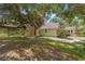 Charming single Gathering home with lush green landscape, large trees and outdoor space at 11933 Pasco Trails Blvd, Spring Hill, FL 34610