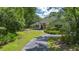 Inviting single-story home featuring manicured landscaping and a winding driveway at 11933 Pasco Trails Blvd, Spring Hill, FL 34610
