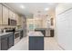 Modern kitchen with an island, stainless appliances, and open floor plan at 11933 Pasco Trails Blvd, Spring Hill, FL 34610