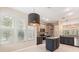 Bright kitchen features stainless appliances, granite countertops, and center island with modern pendant lighting at 11933 Pasco Trails Blvd, Spring Hill, FL 34610