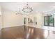 Bright, open living room with dark wood floors and a breakfast bar at 11933 Pasco Trails Blvd, Spring Hill, FL 34610