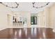 Light filled room featuring dark wood floors and breakfast bar at 11933 Pasco Trails Blvd, Spring Hill, FL 34610