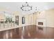 Open concept living space featuring dark wood floors and a fireplace at 11933 Pasco Trails Blvd, Spring Hill, FL 34610